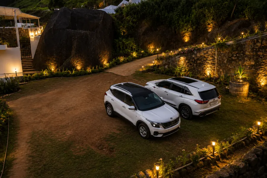 Lit driveway and parking at dusk